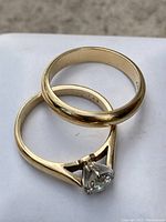 Engagement ring nested inside wedding band on white box, showing overall design and metal color