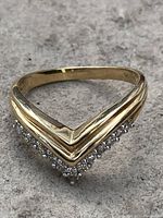 Front V-shaped profile of ring showing diamond-set edge and yellow gold band