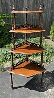 Full front view of the four-tier corner shelf outdoors