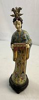 Front view of the Chinese cloisonne and enamel female figurine showing detailed decoration and golden ornamental headpiece.
