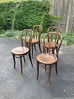 Overview of four matching chairs arranged outdoors