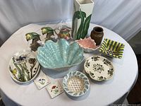 Full lot of 13 hand painted ceramics showing various plates, pitchers, parrots, tiles, and vases in multiple views.
