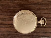 Closed front of full hunter case with floral scroll chasing