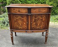 Front view showing two drawers with marquetry inlay above two doors