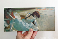 Front cover showing the title 'Impressionism: A Panoramic Postcard Book' with artwork of two ballerinas in light blue dresses.