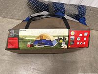 Carrying bag of Ventura McInns 10x8 ft family dome tent with product label showing tent image and features.