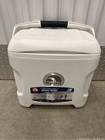 Front view of white Igloo Marine Ultra cooler with label and logo visible.