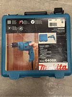 Plastic blue case for Makita 6408K drill, showing model and drill image on front label.