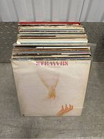 View of vinyl record collection front side featuring Stranrbis album cover with illustration of a dove and hand.