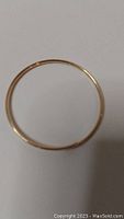 Photo of the entire 10k gold bracelet showing its circular shape.