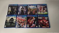 All eight PS4 game cases arranged in two rows showing front covers clearly.