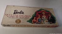 Photo of the Barbie Queen of the Prom game box showing the vintage illustrated cover art with Barbie and friends at prom.