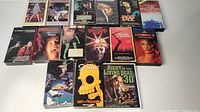 Overview of the horror VHS tapes arranged on a white surface showing titles and artwork.