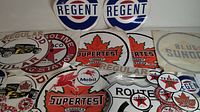 Full lot showing multiple vintage oil and gas decals including Regent, Texaco, Supertet, Mobil, Blue Sunoco, Route 66, and others.