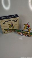 Photo showing the Roy Rogers and Trigger wind-up tin toy next to the original box with vintage graphics.
