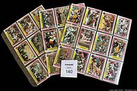 Full view of 70 football cards organized in 3 binder pages, showing front side with player action shots and team logos.