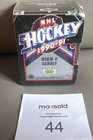 Front view of sealed 1990-91 Upper Deck NHL Hockey High Number Series box showing logos and series year.