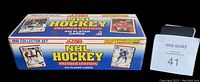 Front and top view of the original factory-sealed blue rectangular box labeled "1990 Score NHL Hockey Premier Edition 445 Player Cards" with images of Wayne Gretzky and Eric Lindros hockey cards.