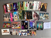 Photo showing a broad assortment of colorful non-sport promotional cards from Dart Flipcards laid out, featuring various pop culture series.
