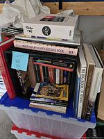 Photo of stacked books showing titles like Black History Month Resource Book, Zen, The Big Book of Hymns, and others, in mixed hard and paper backs.