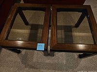 Four square wooden tables each with a glass top inset, arranged together and photographed to show top view and front view.