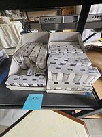 12 packs of IKEA UPPEHÅLL votive candle holders in original packaging stacked in a box, showing quantity and packaging condition
