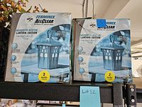 Two boxed Terminix AllClear Mosquito Mister Lantern Edition units on a shelf, showing front of boxes with product image and labeling.
