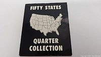 Black folder cover with white text 'Fifty States Quarter Collection' and a map of the United States.