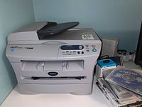 Front view of Brother DCP 7020 laser multifunction printer/copier/scanner showing control panel, paper trays, and automatic document feeder.