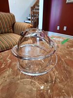 Clear Rosenthal art glass vase with an applied swirl design around the body seen from side angle.