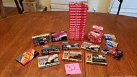Photo showing the collection of cassette tapes and mini DV tapes arranged on a table with a lot number card 52