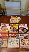 Seven Mad magazines laid out on a table, showing a range of Mad Super Special issues and one Worst of Mad special annual issue.