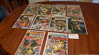 Lot of 10 Marvel Comics featuring Man-Thing and related covers laid out on table, showing front covers and partial details of each issue.