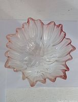 Top-down view of the Mikasa tulip glass bowl showing detailed petal shapes and pink tinting on ruffled edges.