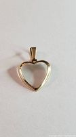 Front view of the yellow gold heart-shaped pendant with smooth polished surface and open center.
