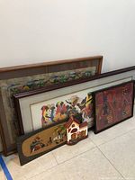 Overview of all plaques and framed artworks against the wall
