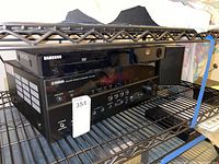 Yamaha RX-V663 receiver and Samsung BD06500 DVD player stacked on a metal shelf