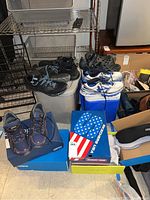 Overview of five pairs on floor with boxes