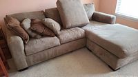 Front left angle view showing full L-shaped sectional with chaise and pillows
