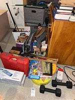 General overview of various items on floor including toys, sports equipment, and boxes.