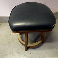 Top down view showing vinyl seat and wooden frame.