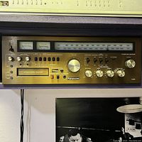 Front view of Panasonic stereo receiver and 8-track tape player unit showing control knobs, tuner dial, and tape deck.