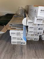 Stack of labeled flooring boxes on basement floor
