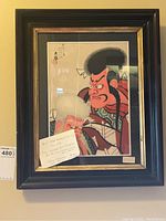 Framed print hung on wall, note on glass