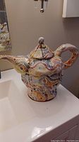 Full teapot shot front-side showing spout, handle, and body