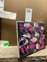 Front-right angled view of the small abstract oil painting showing impasto strokes