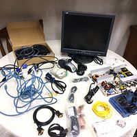 Overview photo of the electronic items spread on a table including the Philips monitor, cables, printed circuit board, Zip drive, and other components.