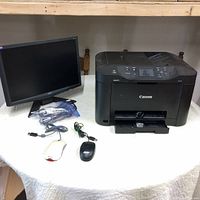 Wide view on table showing Canon Maxify MB5020 printer on right, Acer monitor left, two computer mice and cables on table between.