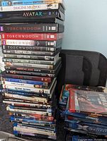 Stack of DVDs featuring Torchwood, Avatar, Sleepy Hollow, Imagine Me and You, American Gods, Lucifer, and various BBC series.