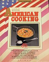 Cover of A Guide to Modern American Cooking showing the title, author Pol Martin, and a skillet with food on an American flag themed background.